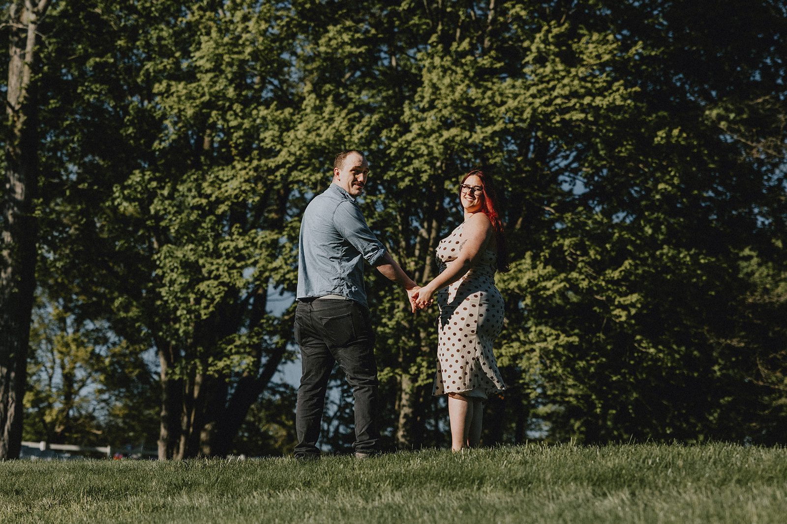 A portrait of the couple framed by the evening sun and the beauty of the garden