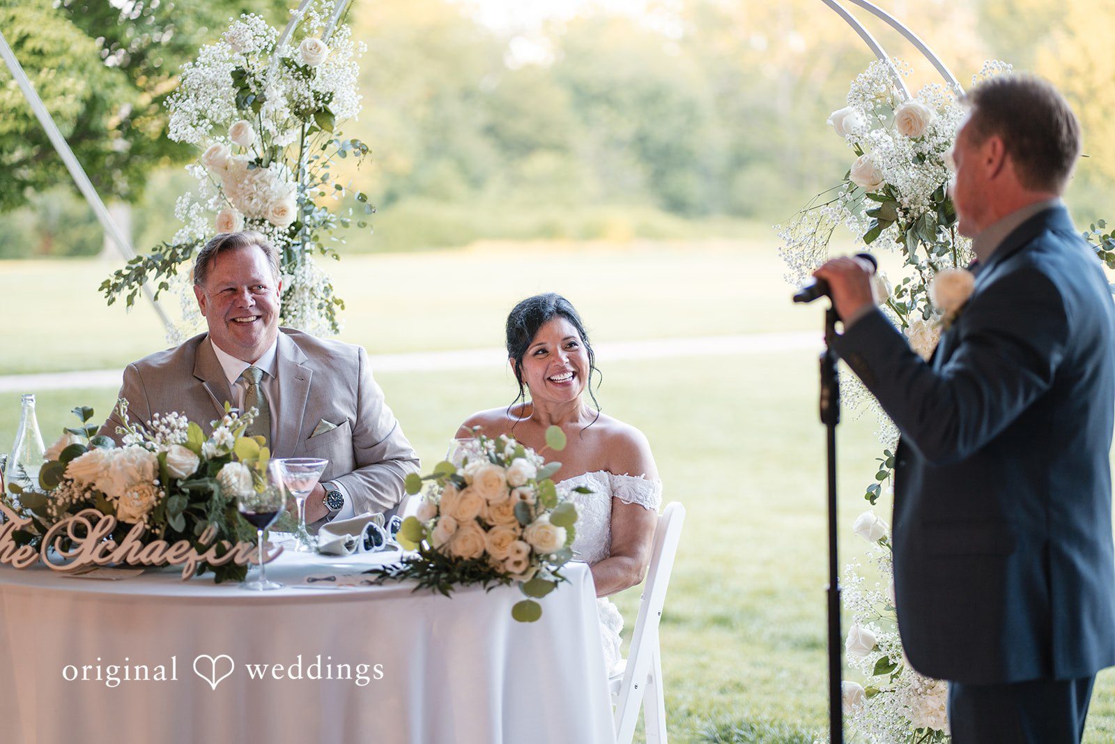 Romantic reception table picture of couple while smiling  at Swan Harbor Farm