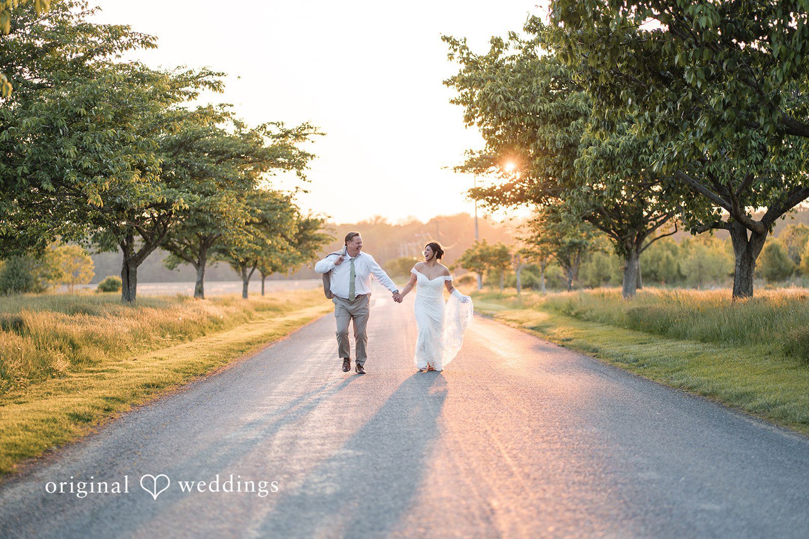 Baltimore Wedding Photographers capturing couple walking while smiling at Swan Harbor Farm by Original Weddings
