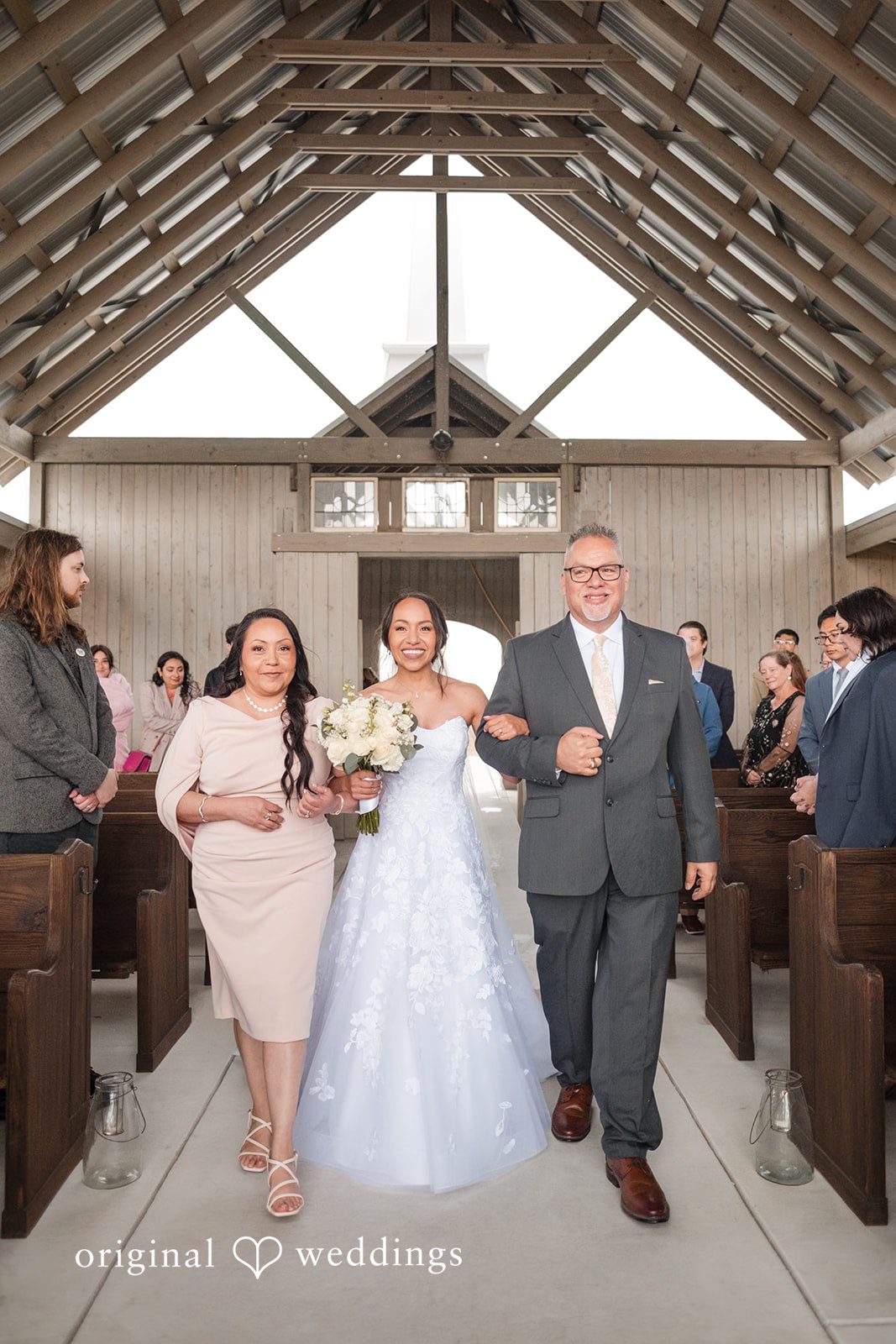 Dana + Daniel Bride walking down the aisle with her family