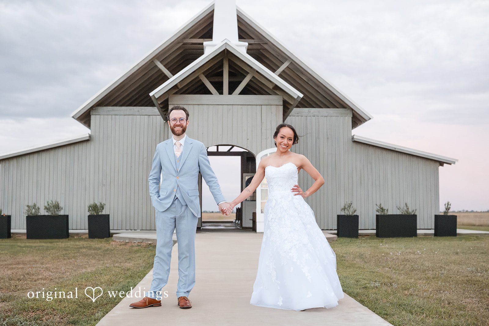 Dana + Daniel Happy bride and groom portrait in front of the venue