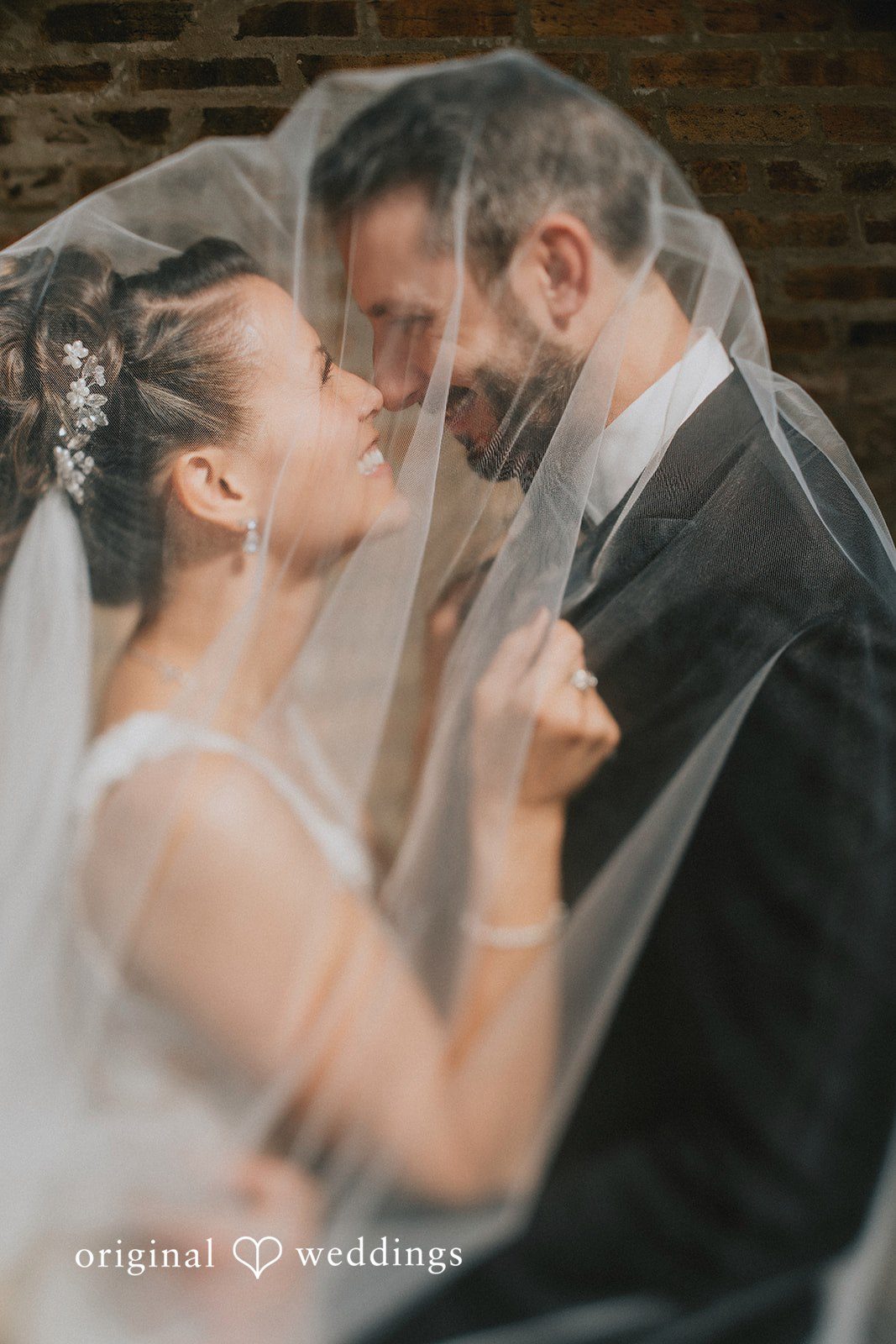 A beautiful portrait of the couple covered in veil