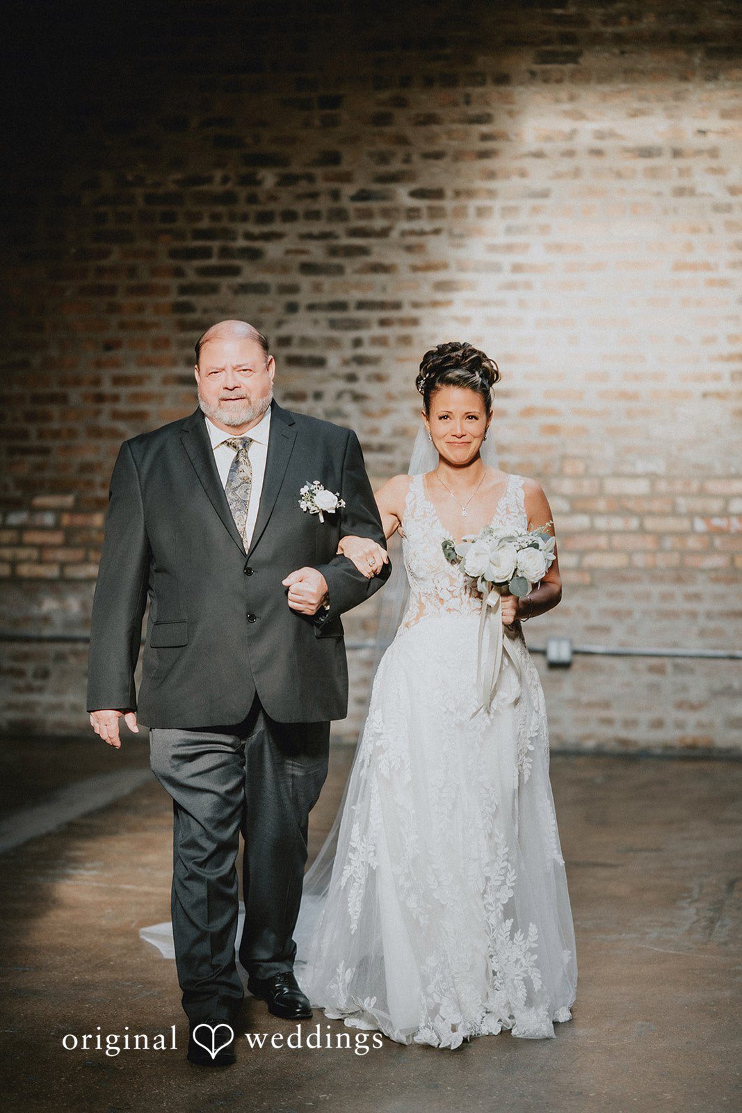 The bride's father escorts bride down the aisle