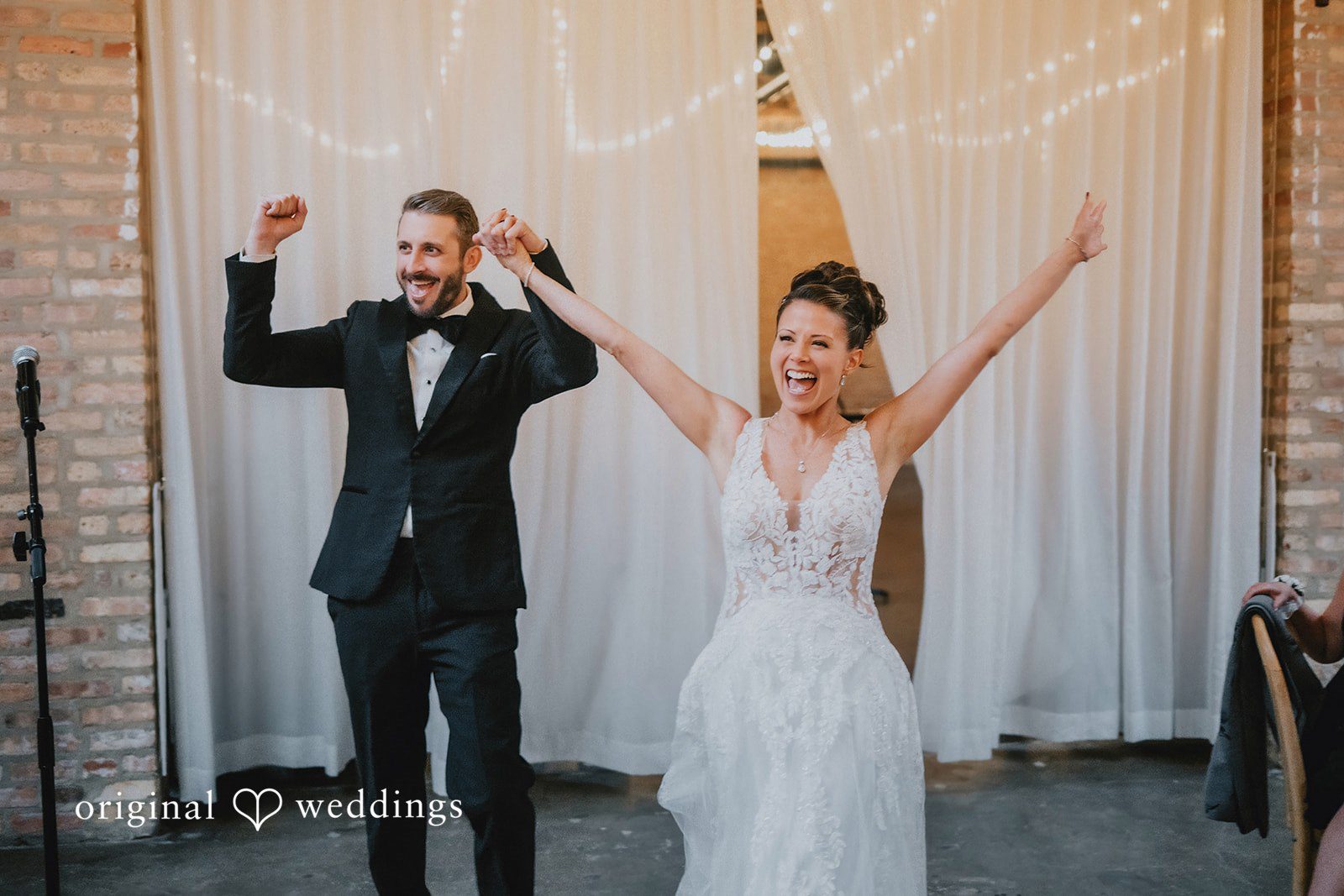 The couple makes a joyful entrance into their wedding reception