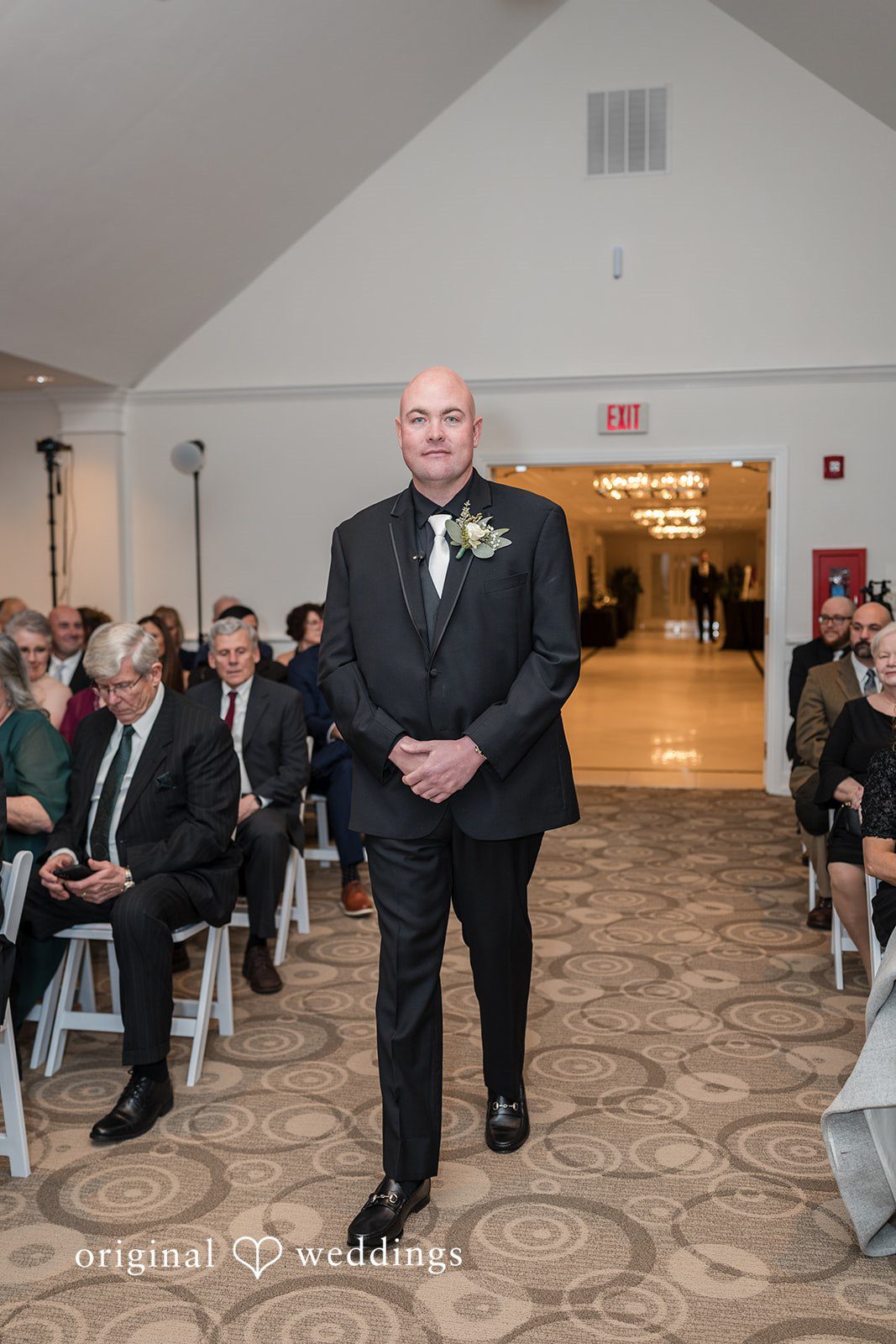 Elegant picture of groom walking down the aisle
