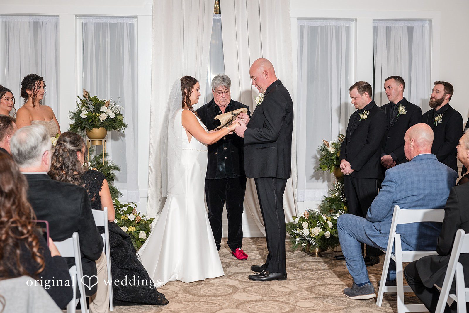 Romantic picture of couple hands in hands during ceremony