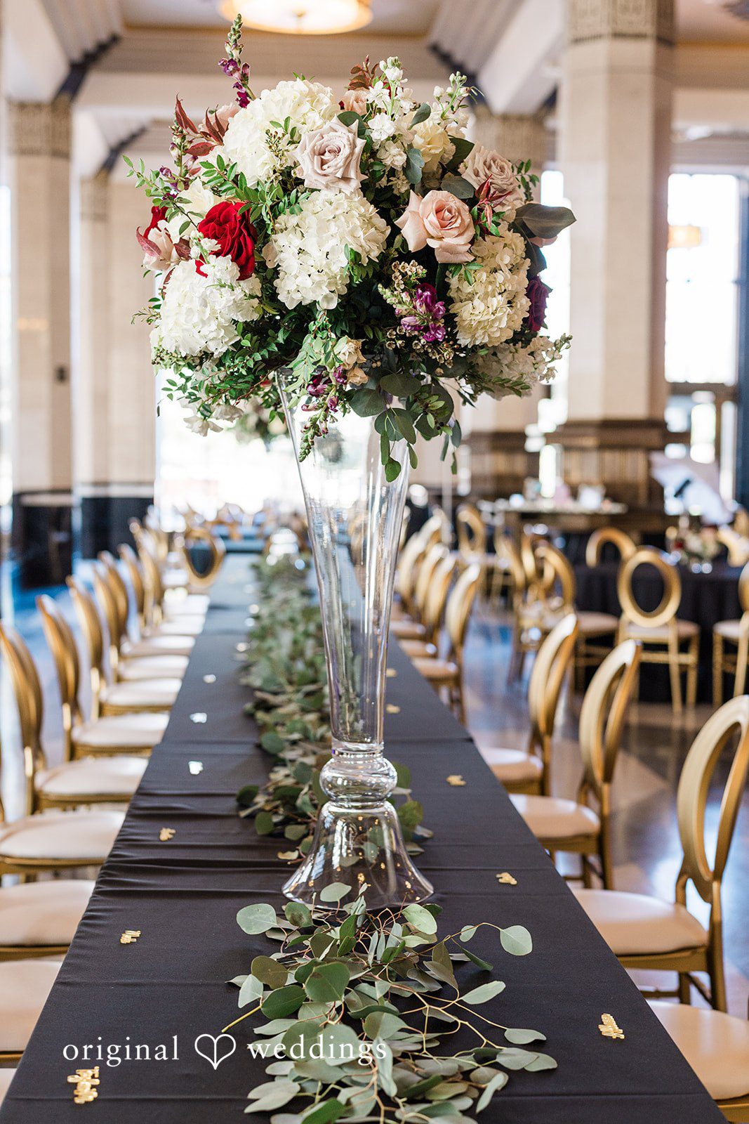 Elegant dining table decorated with flowers in glass vases at The Carlisle Room