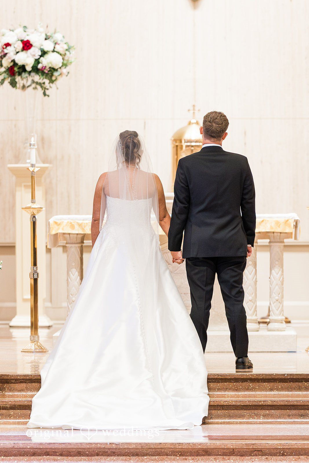 Candid hand-holding moment between bride and groom at The Carlisle Room