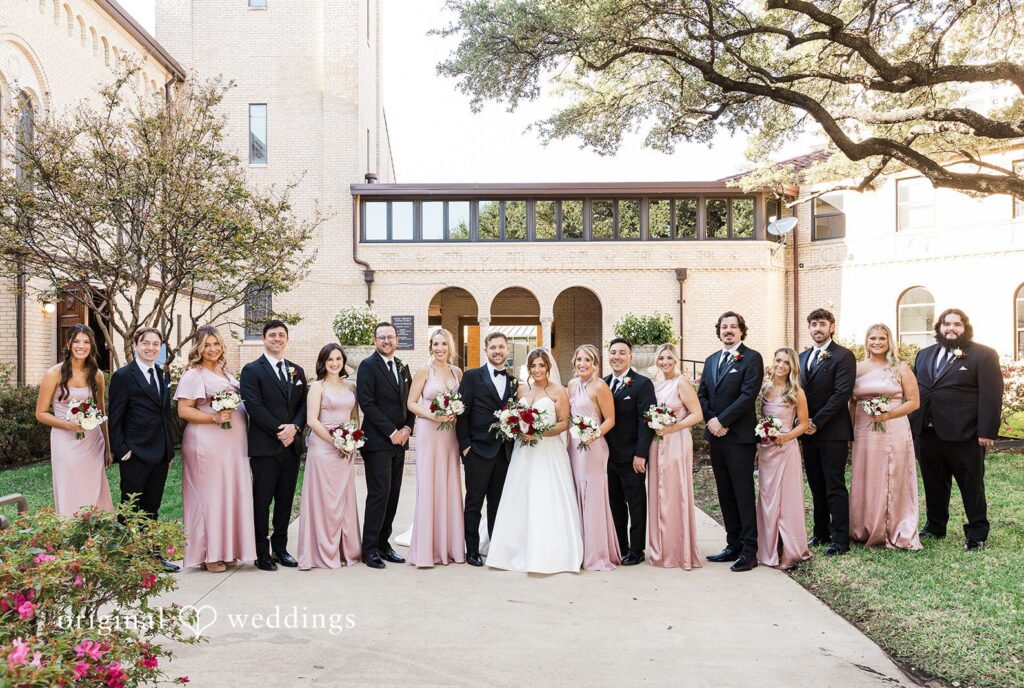 Dallas wedding photographers capturing group portrait of couple with bridesmaids and groomsmen at The Carlisle Room by Original Weddings