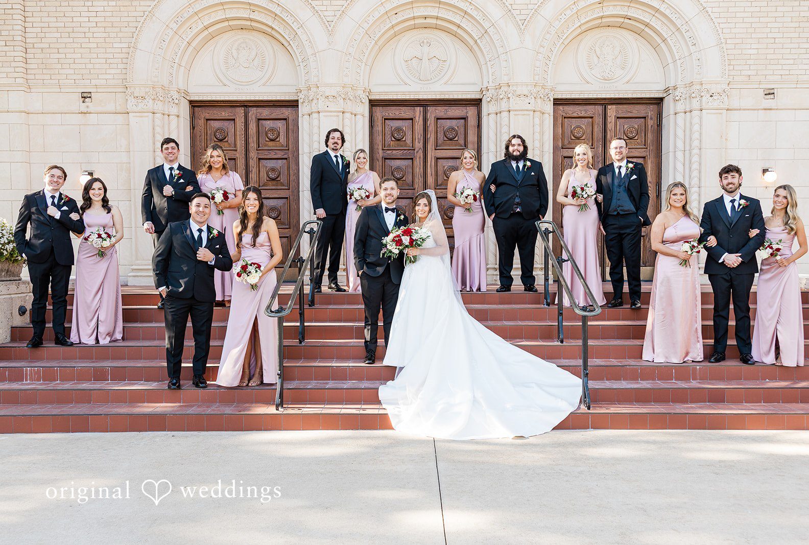 Dallas wedding photographers capturing group portrait of couple with bridesmaids and groomsmen at The Carlisle Room by Original Weddings