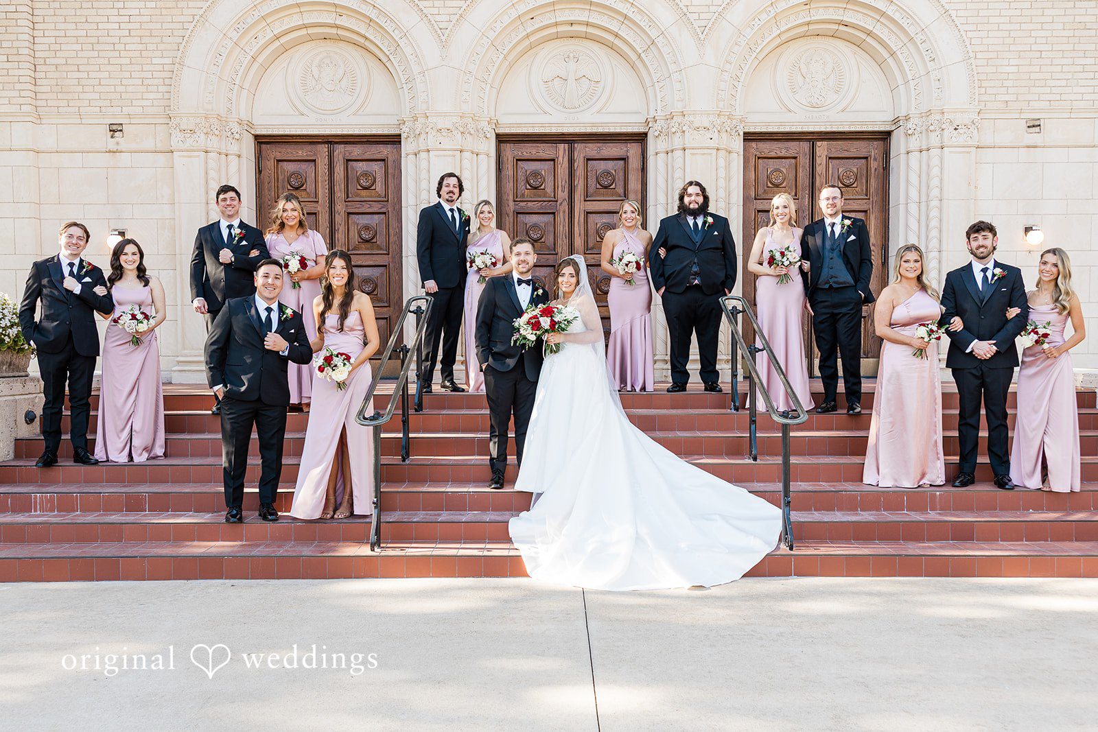 Dallas wedding photographers capturing group portrait of couple with bridesmaids and groomsmen at The Carlisle Room by Original Weddings