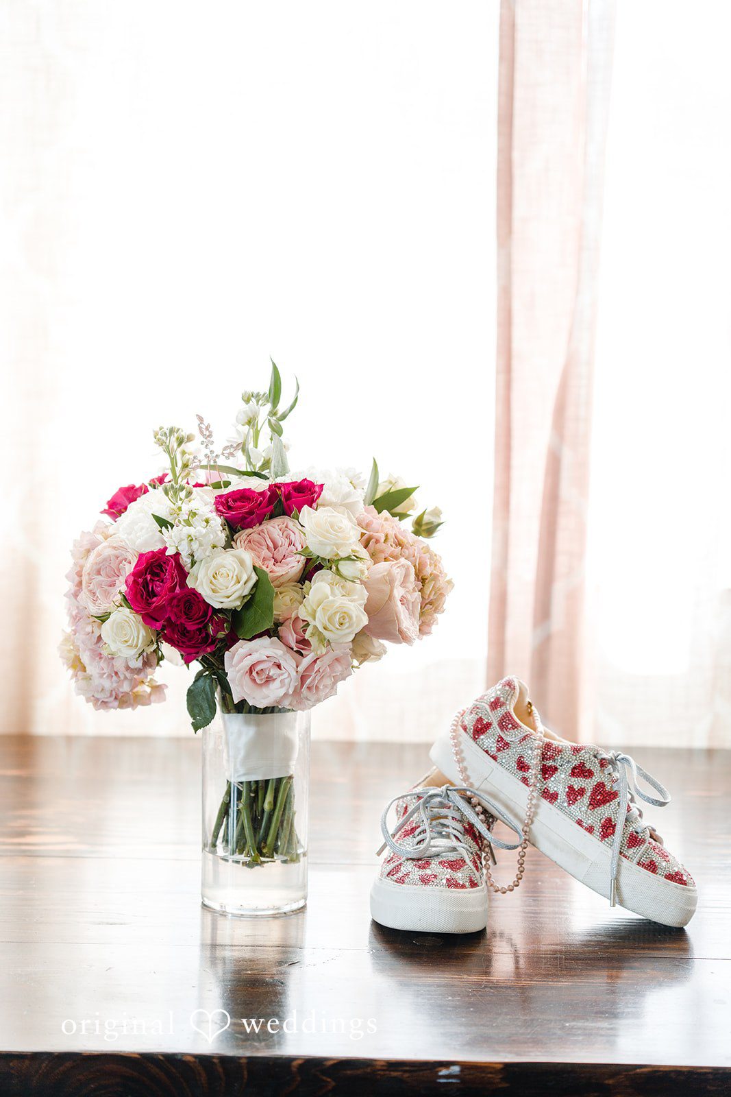 Bridal shoes placed beside decorative vase