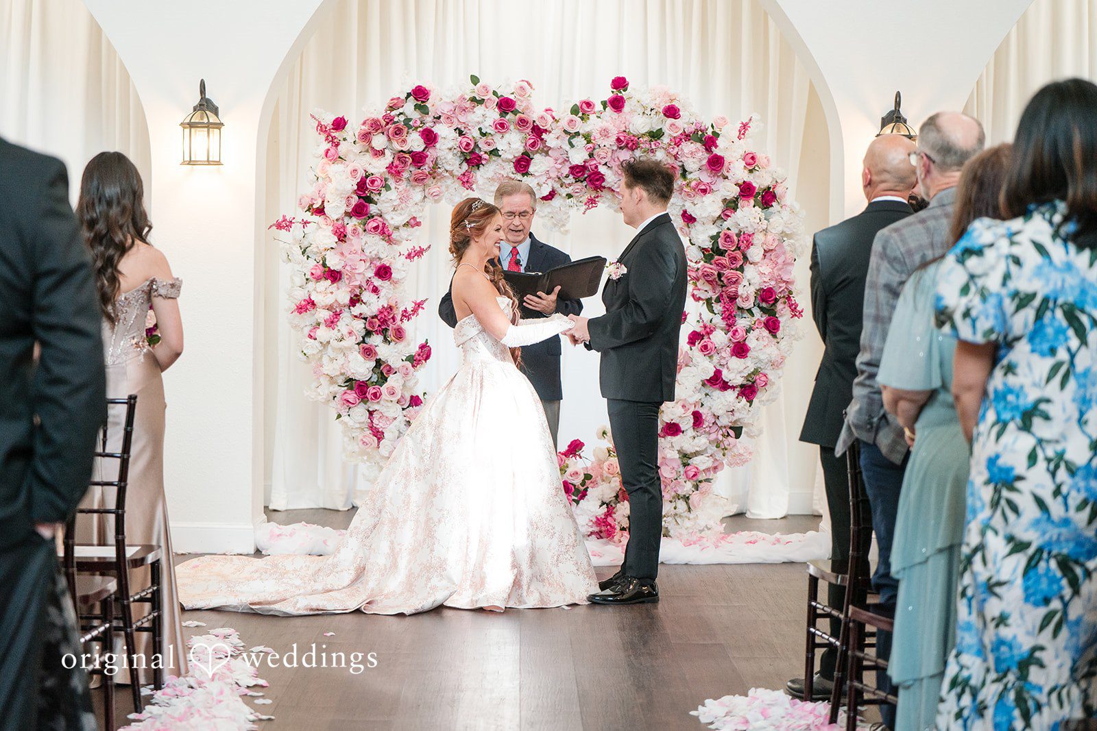 Couple holding hands and looking at each other during ceremony