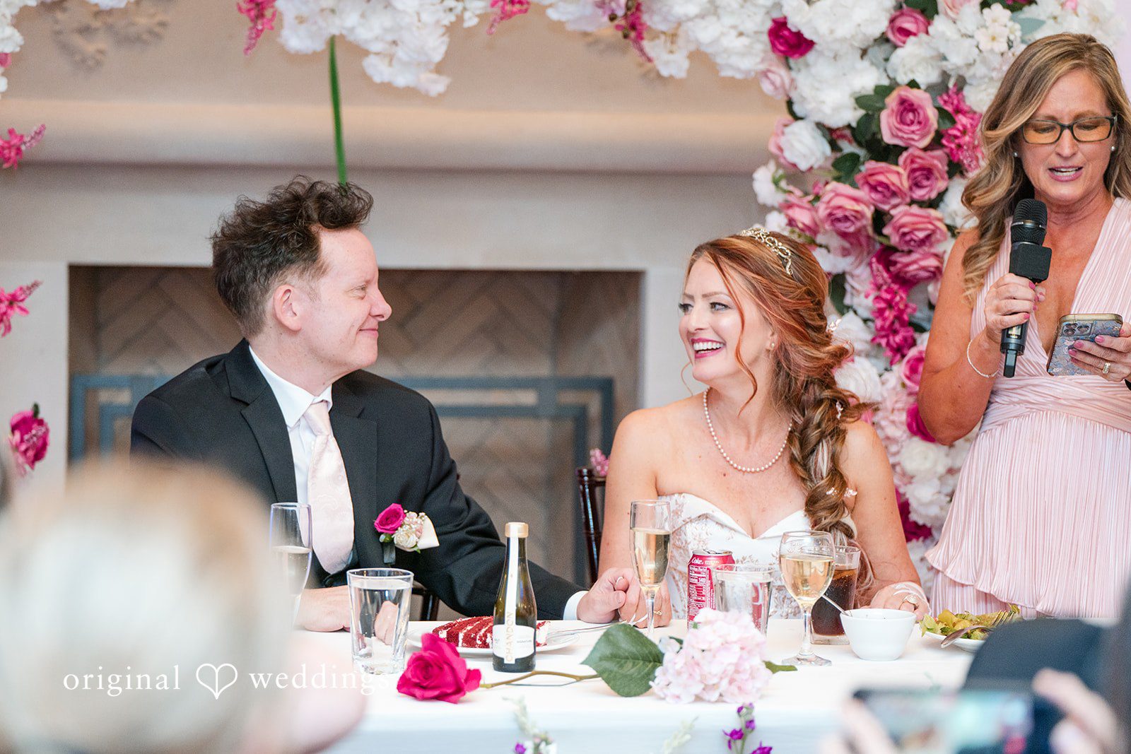 Dallas Wedding Photographers capturing bride and groom seated at reception table