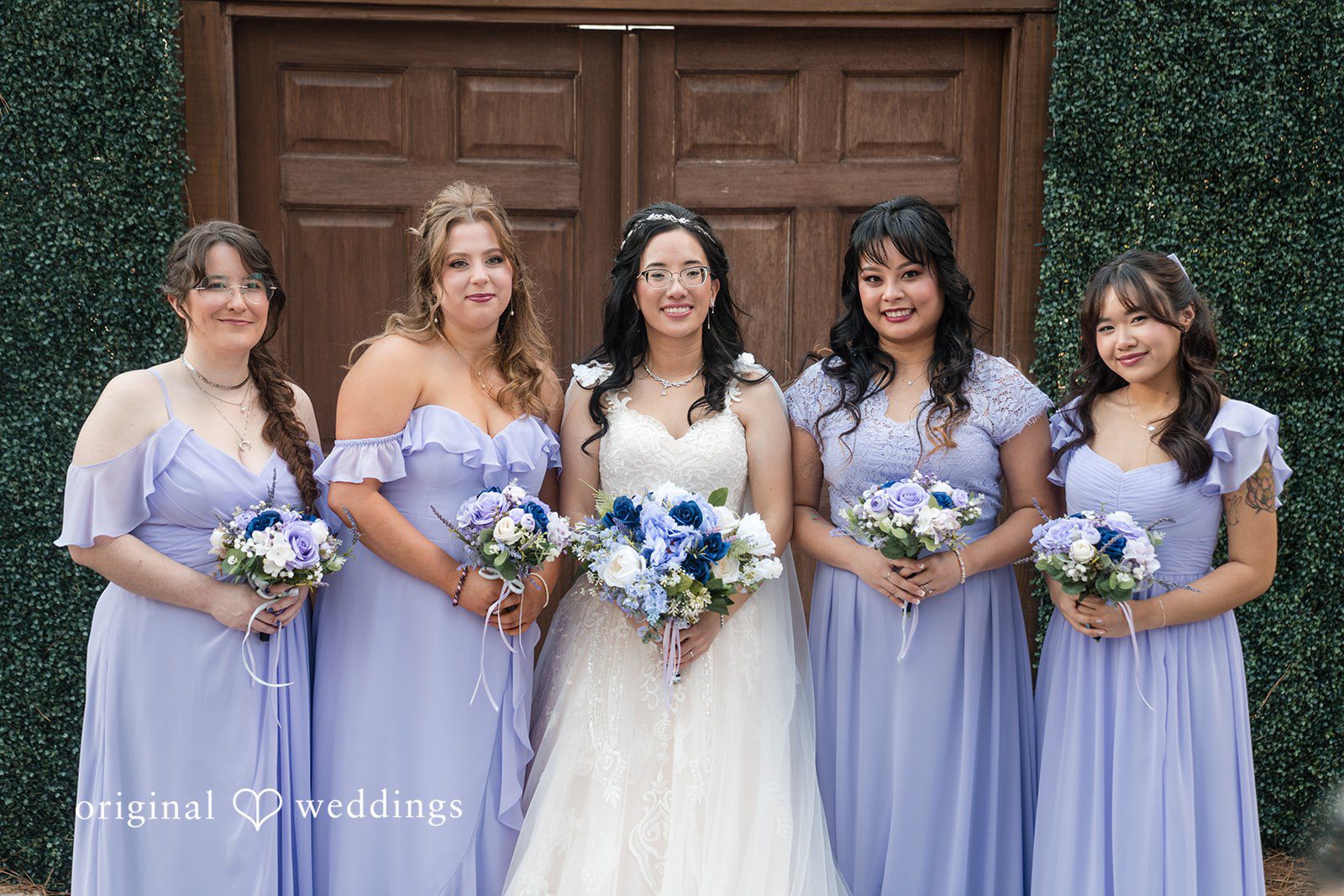 Nghi + Christopher Happy bride posing with bridesmaids in elegant wedding dresses at The Castle at Wildwood Gardens