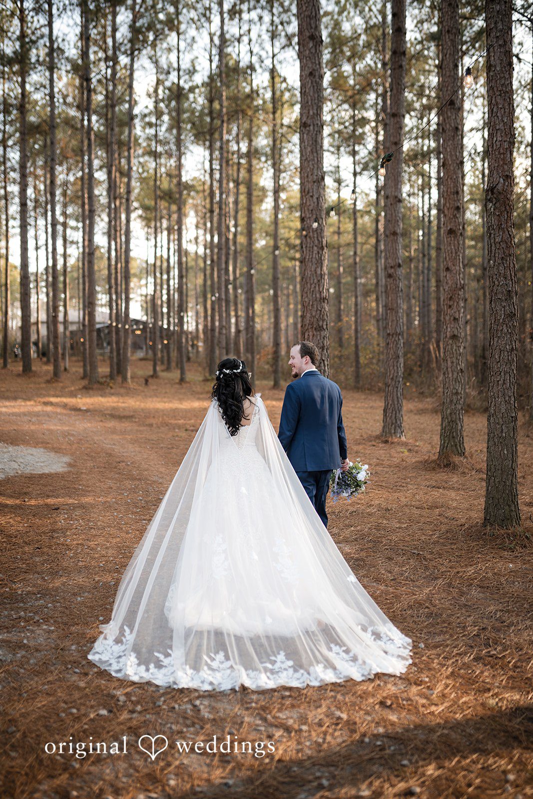 Nghi + Christopher Romantic wedding photography featuring the couple from behind at The Castle at Wildwood Gardens