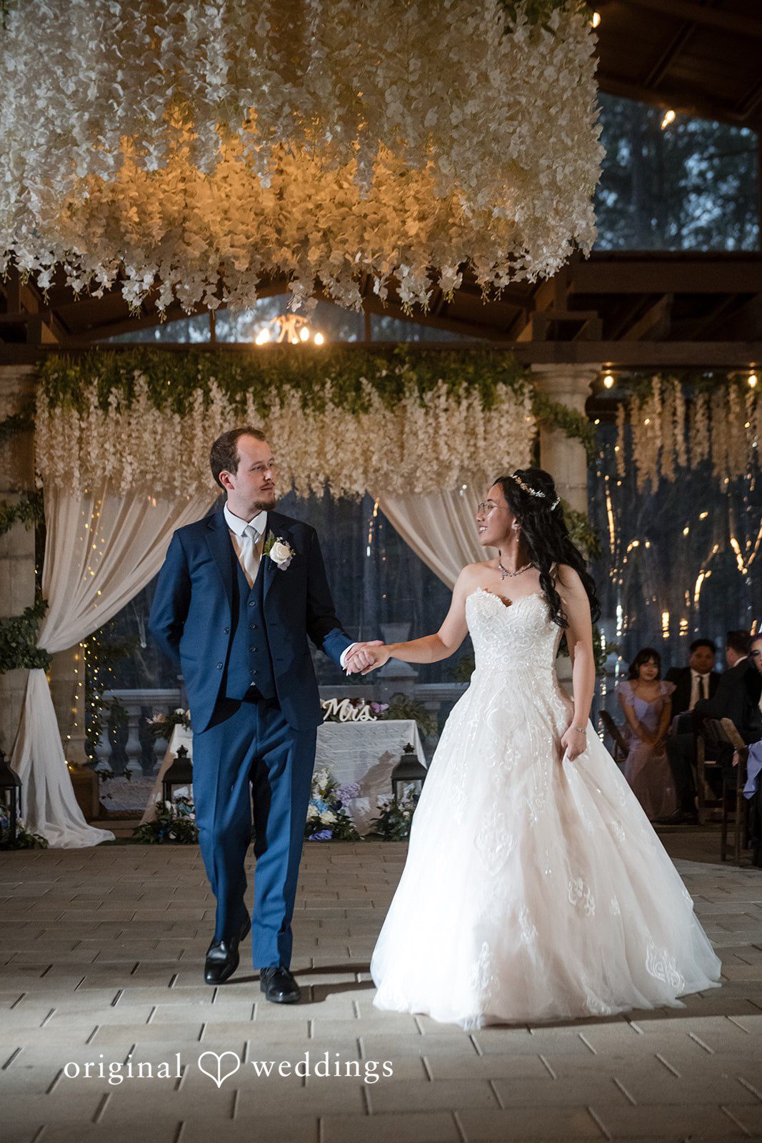 Nghi + Christopher Romantic reception entrance moment of the bride and groom at The Castle at Wildwood Gardens