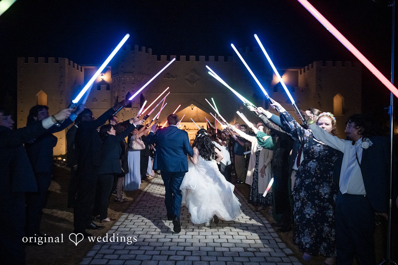 Nghi + Christopher Romantic reception exit moment from the back captured with happiness and laughter at The Castle at Wildwood Gardens