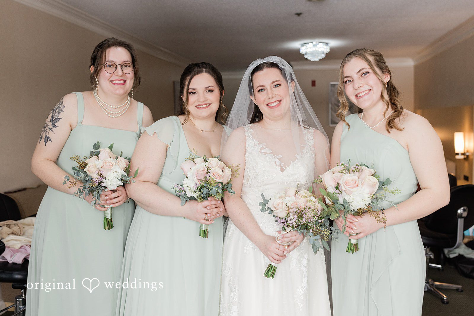 Bride with bridesmaids sharing joyful moment