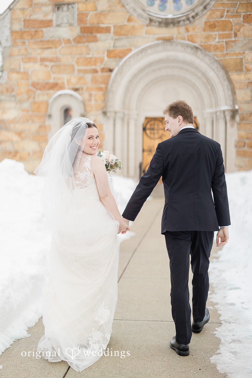 Bride and groom holding hands at The Chapel at West Parish