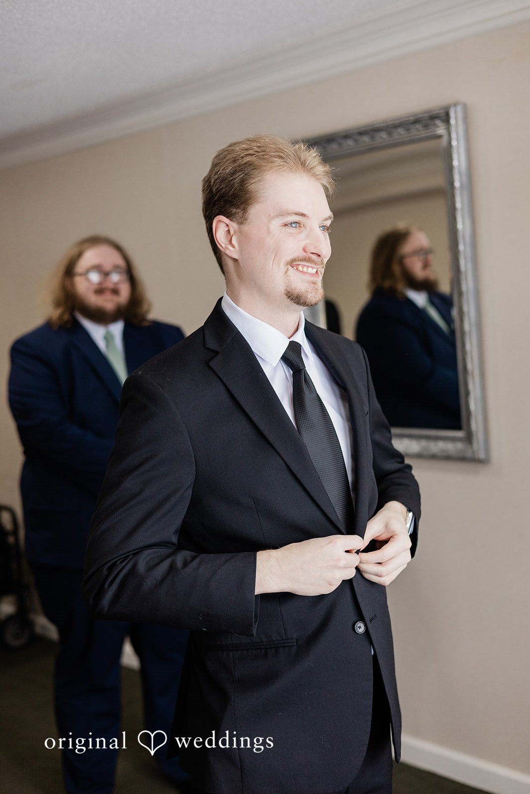 Groom adjusting his suit before wedding ceremony