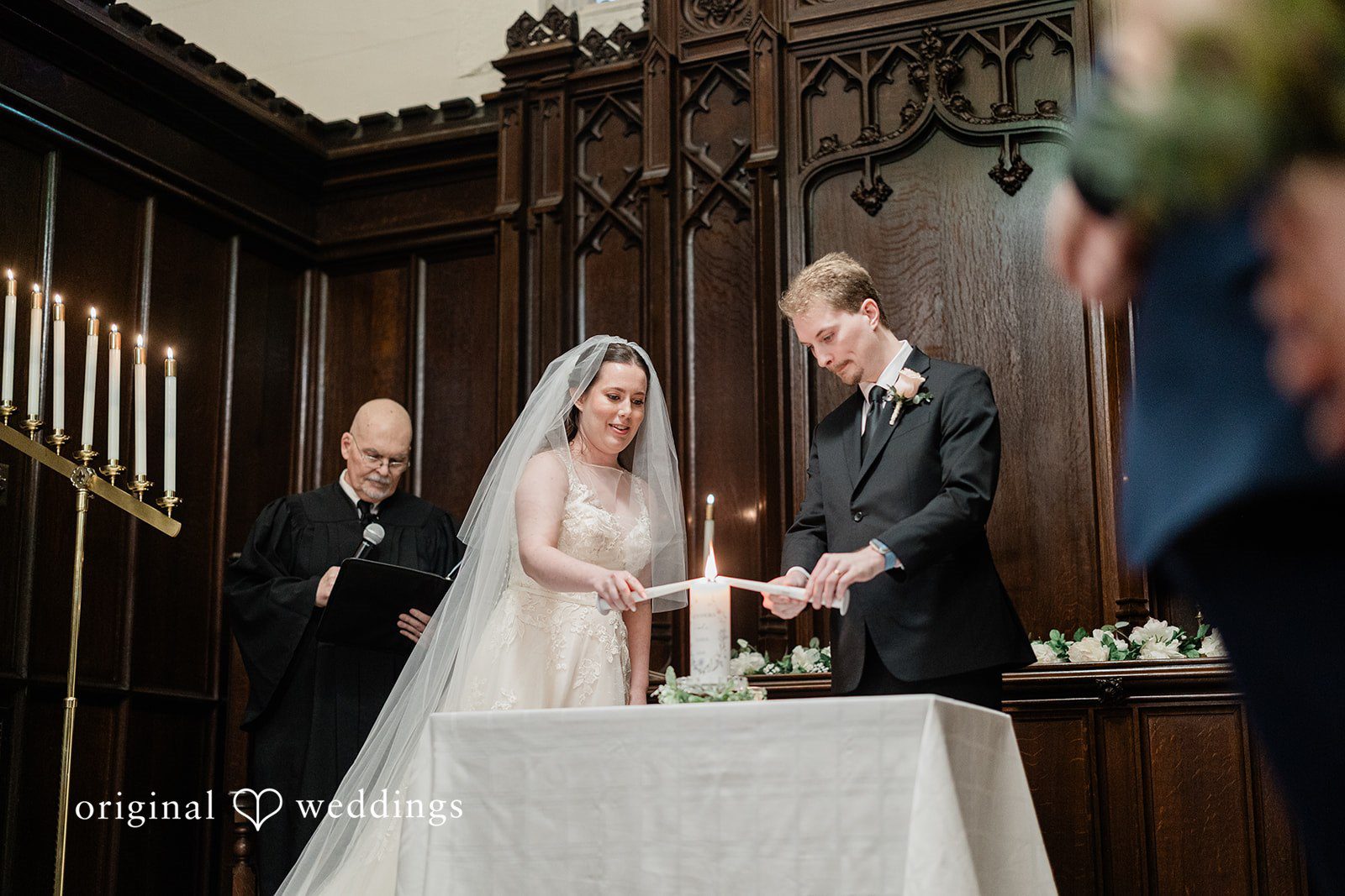Boston Wedding Photographers capturing couple lighting unity candle at The Chapel at West Parish from Original Weddings during ceremony