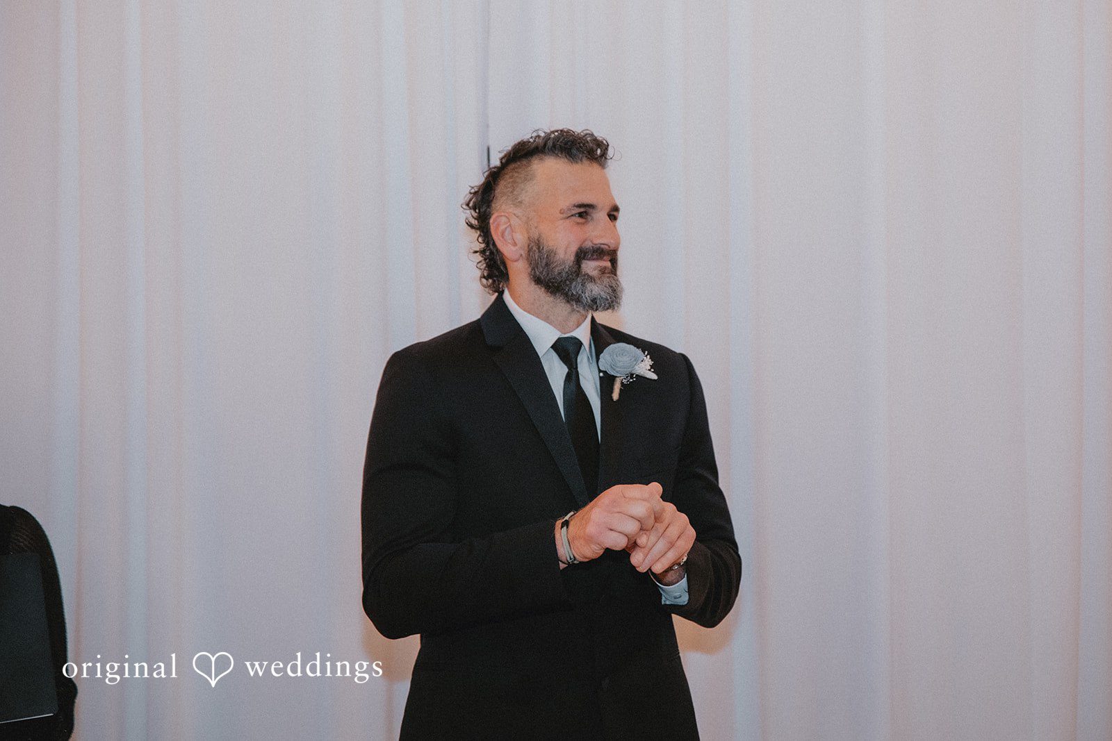 Siobhan + Seth Groom smiling during ceremony