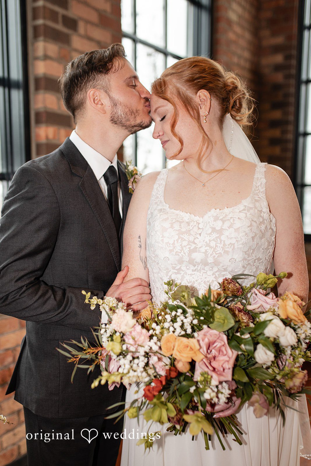 Romantic forehead kiss portrait at The Essence Event Center