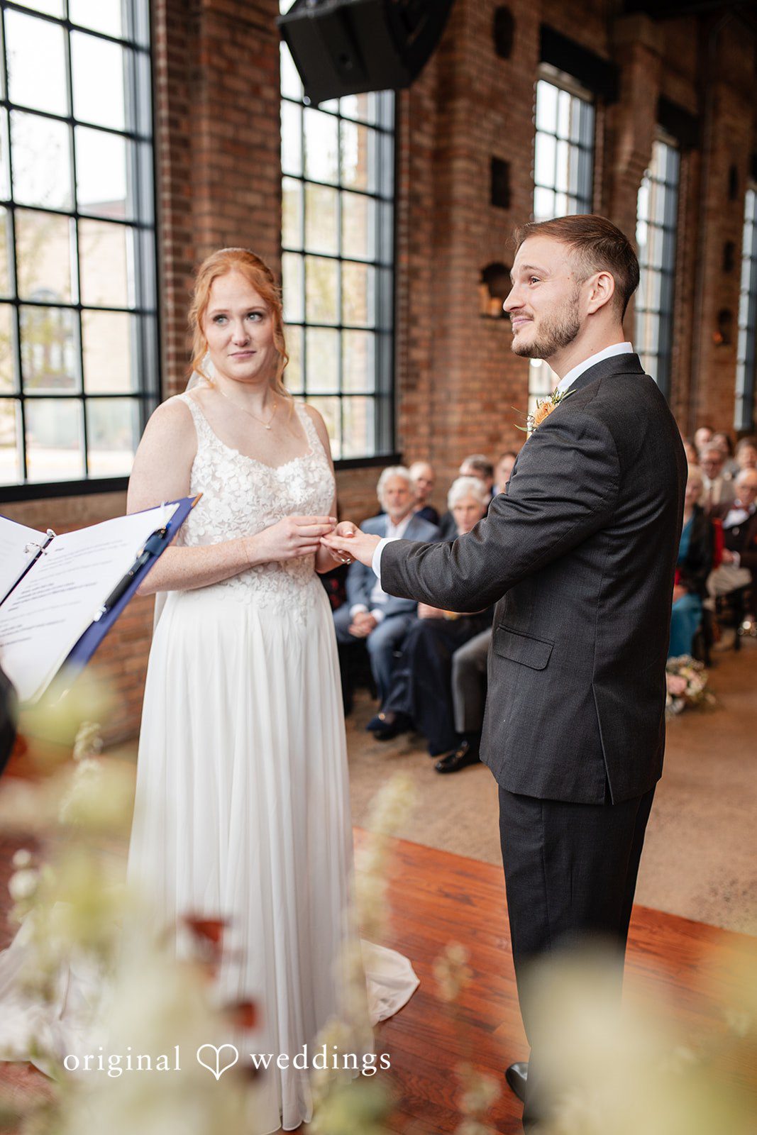 Romantic wedding ring exchange moment at The Essence Event Center