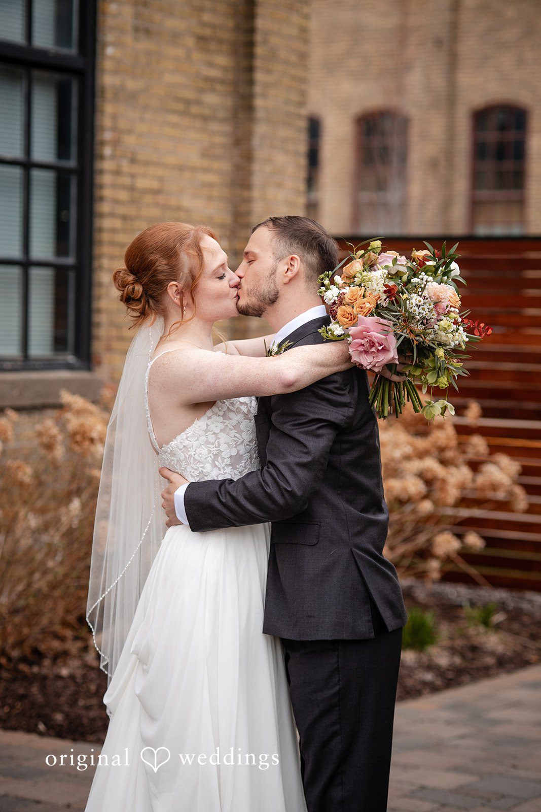 Elegant wedding kiss photography at The Essence Event Center