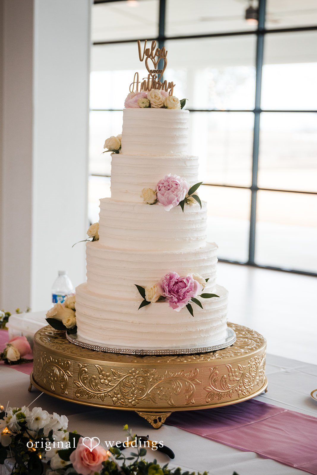 Anthony + Valen Amazing shot of wedding cake decorated with flowers