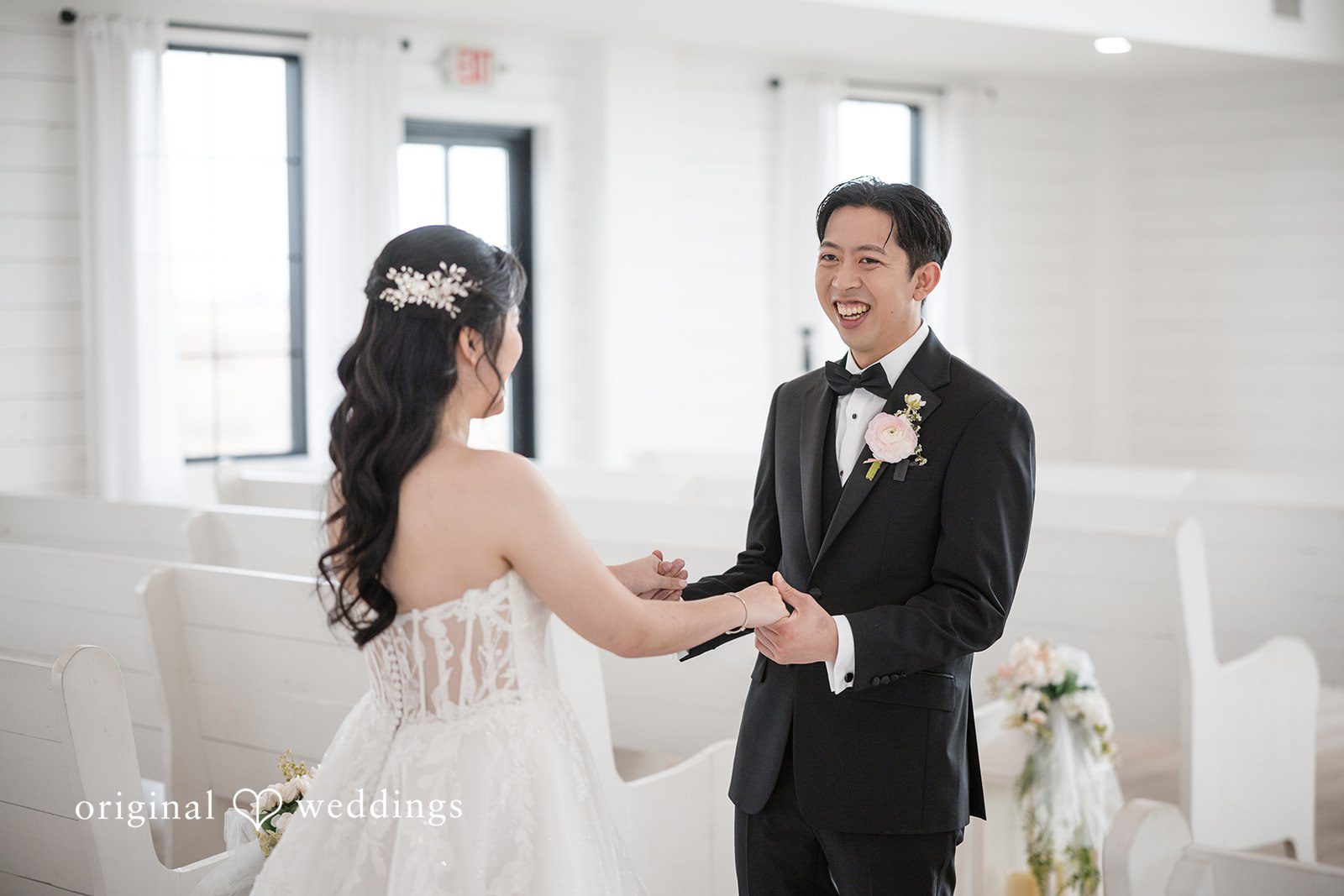 Anthony + Valen Groom holding the hands of bride and smiling.
