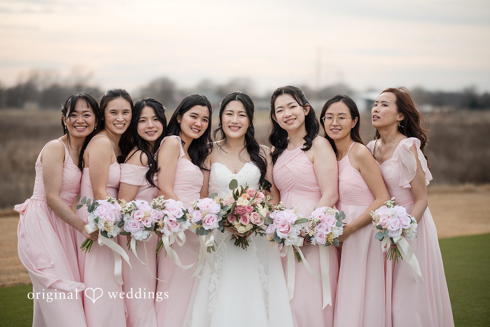 Anthony + Valen Group photo of bride with bridesmaids, smiling and holding bouquets