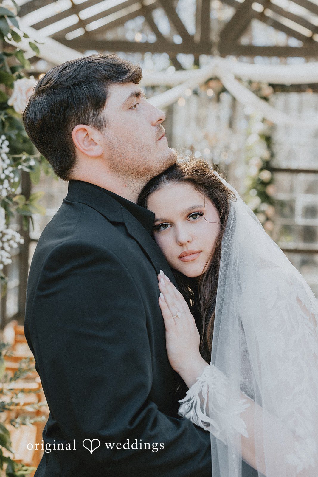 Couple sharing a loving hug at The Glasshouse at Alabama Eden