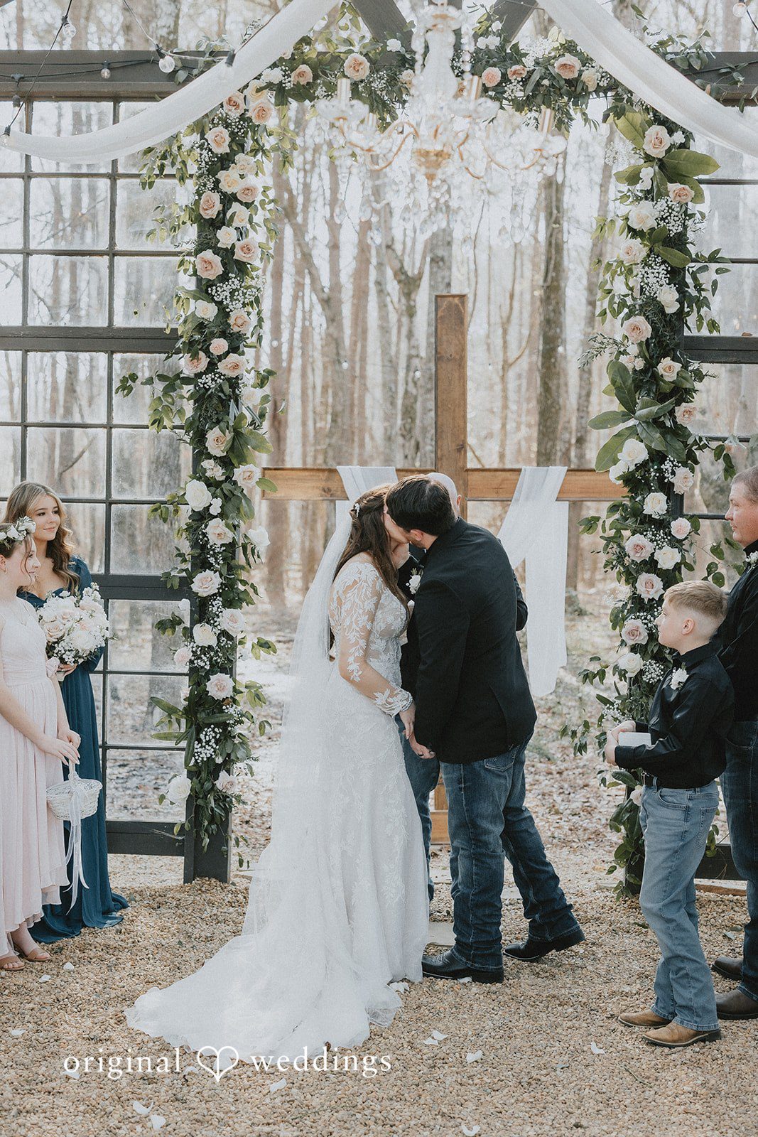 Bride and groom sharing a kiss during ceremony