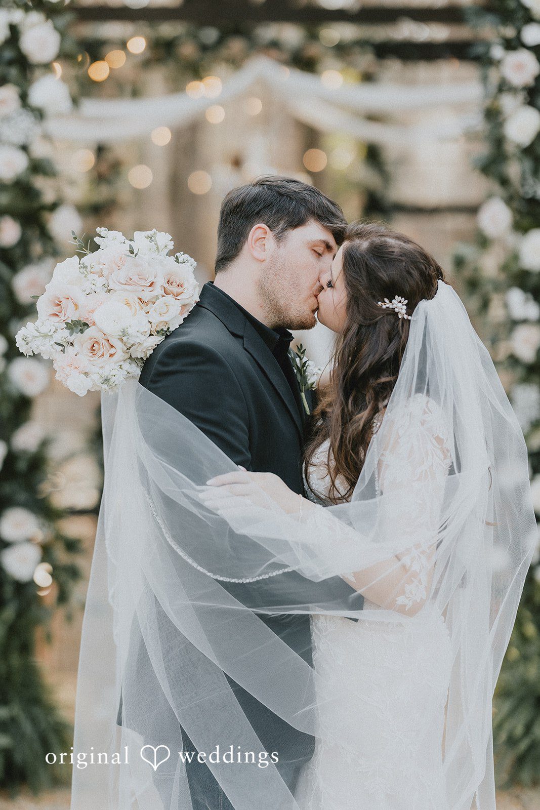 Atlanta Wedding Photographers capturing romantic wedding kiss moment at The Glasshouse at Alabama Eden by Original Weddings