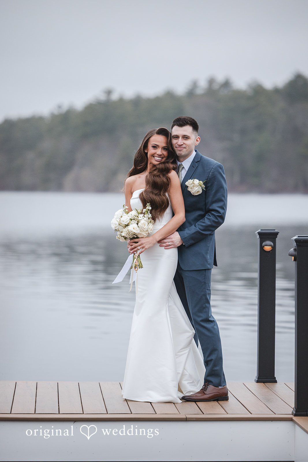 A stunning portrait of the couple by the lake