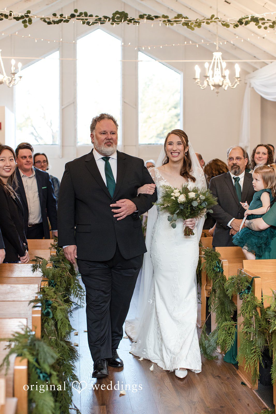Adam + McKenzie Processional moment walking down the aisle inside The Larimore ceremony space