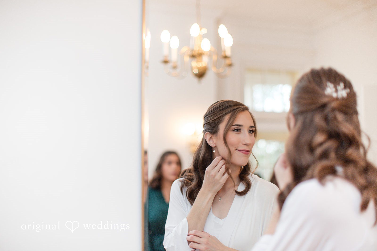 Adam + McKenzie Getting ready moment with hair and makeup in a bright indoor space