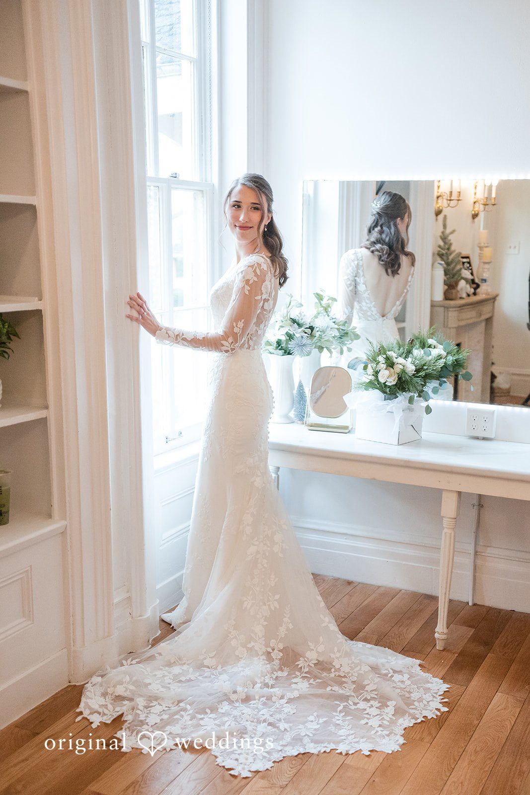 Adam + McKenzie Bride portrait by the window with flowing dress and soft natural light