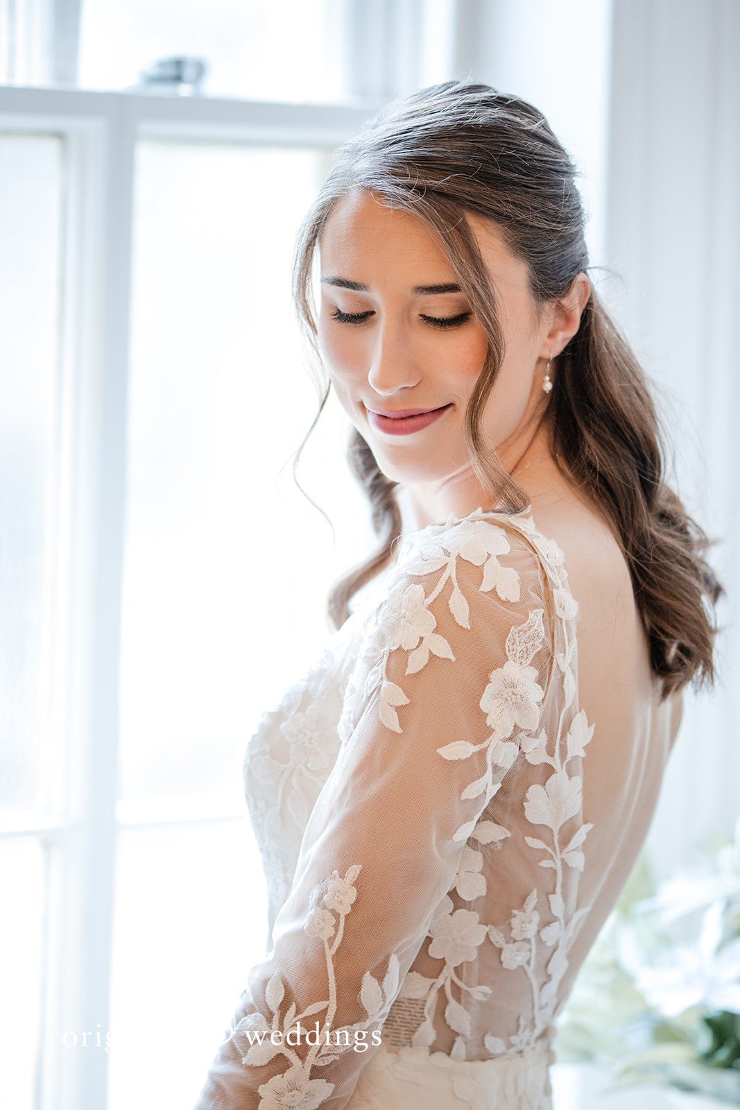 Adam + McKenzie Soft bridal portrait highlighting lace sleeve details and natural glow