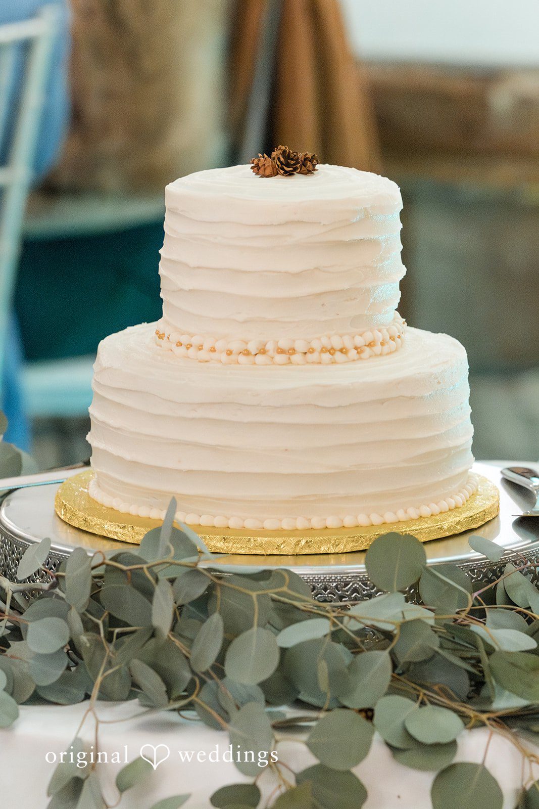 Adam + McKenzie Elegant tiered wedding cake with greenery details captured by St. Louis wedding photographers at The Larimore