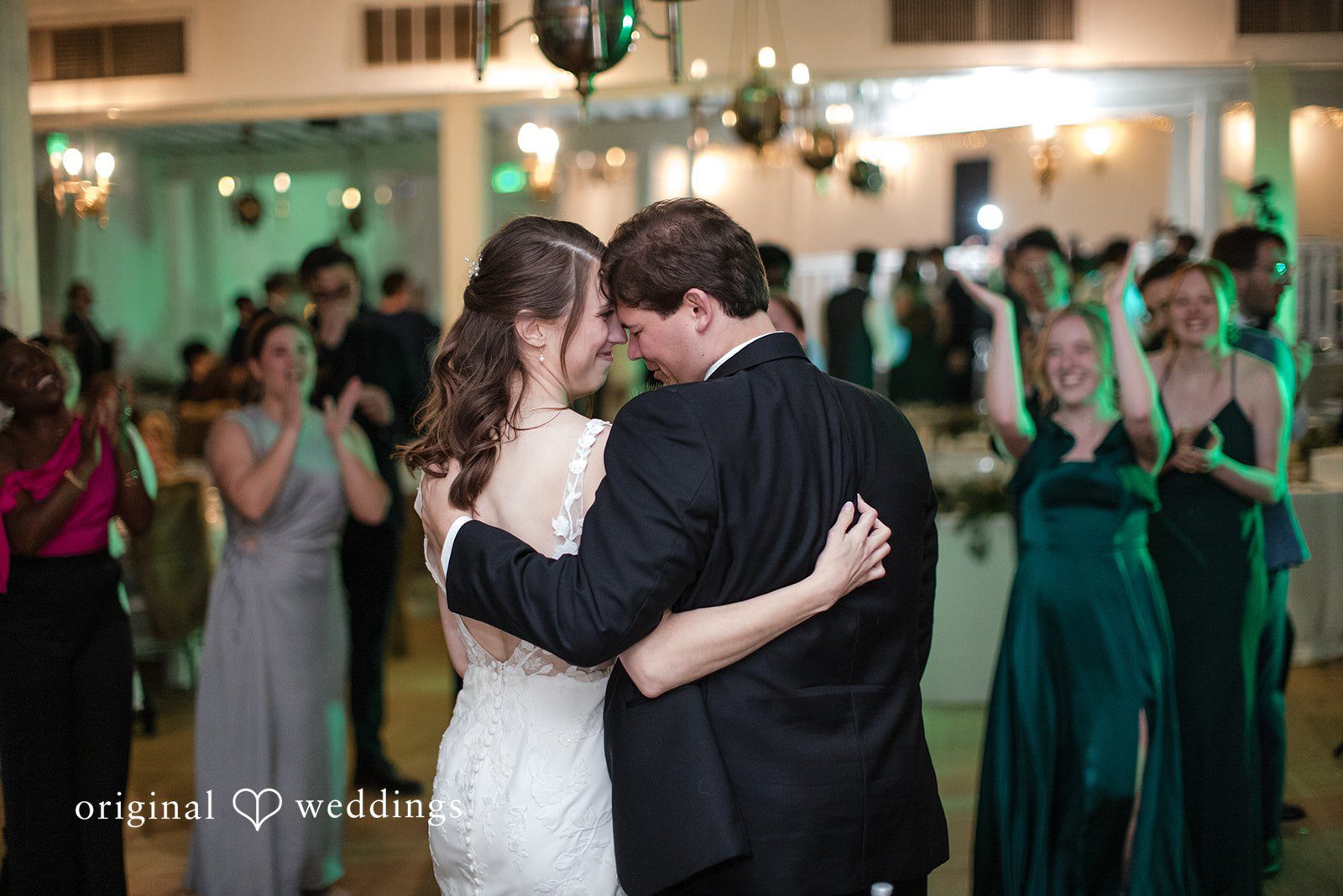 Adam + McKenzie Romantic slow dance surrounded by guests and reception lights