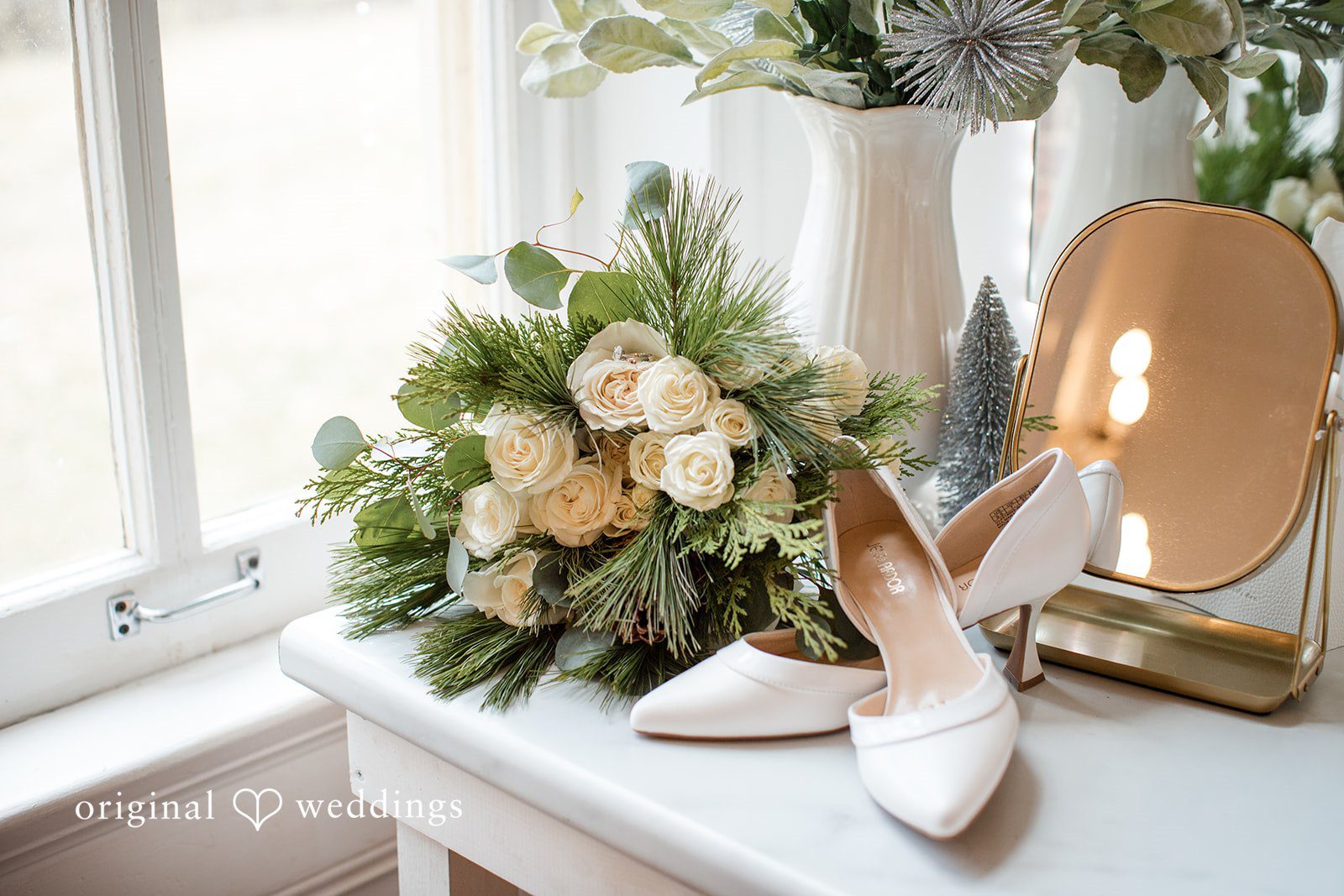 Adam + McKenzie Bridal shoes and bouquet displayed by a window with soft daylight
