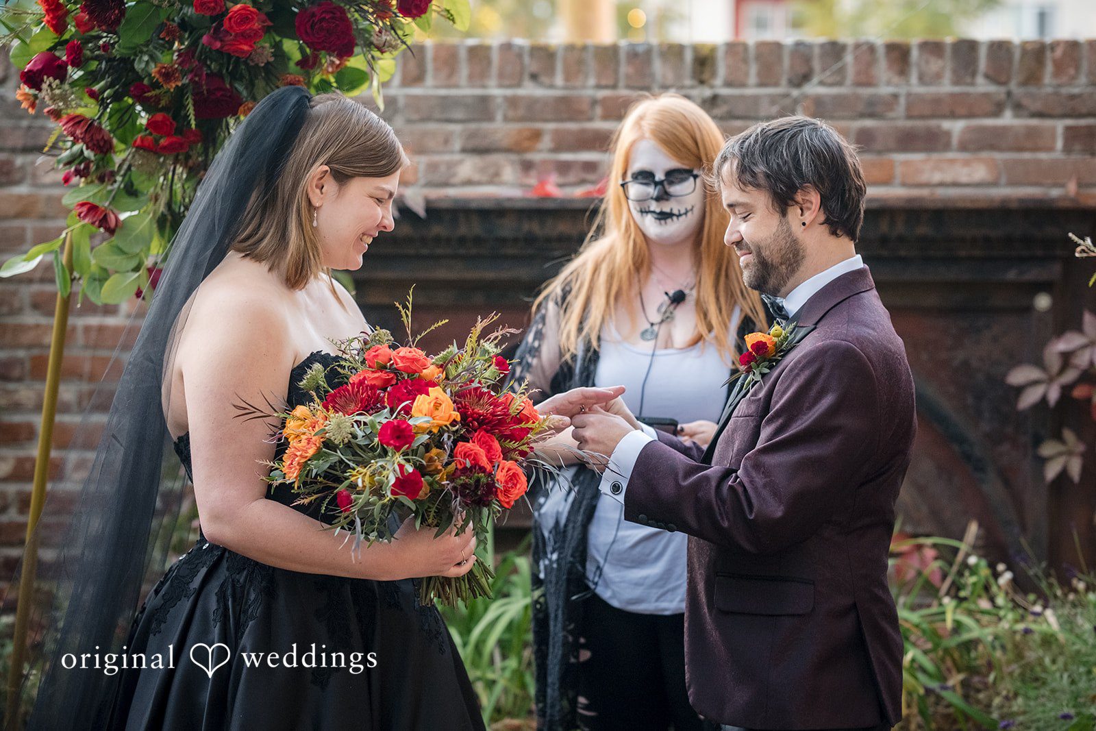 Denver Wedding Photographers capturing groom placing ring on bride at The Lobby by Original Weddings
