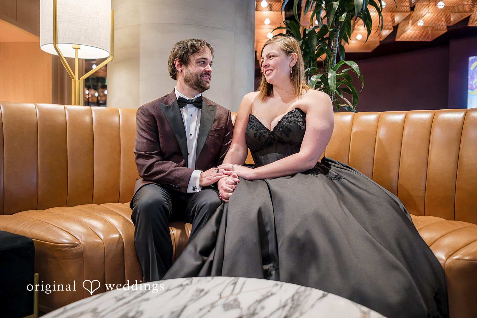Denver Wedding Photographers capturing couple sitting on sofa at The Lobby by Original Weddings