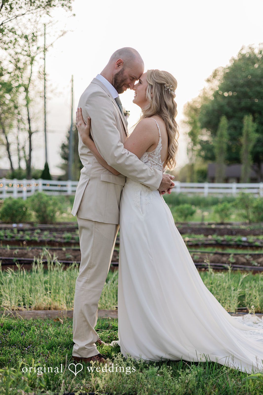 Lily + Robert A romantic portrait of the couple framed by the greenery at the wedding venue