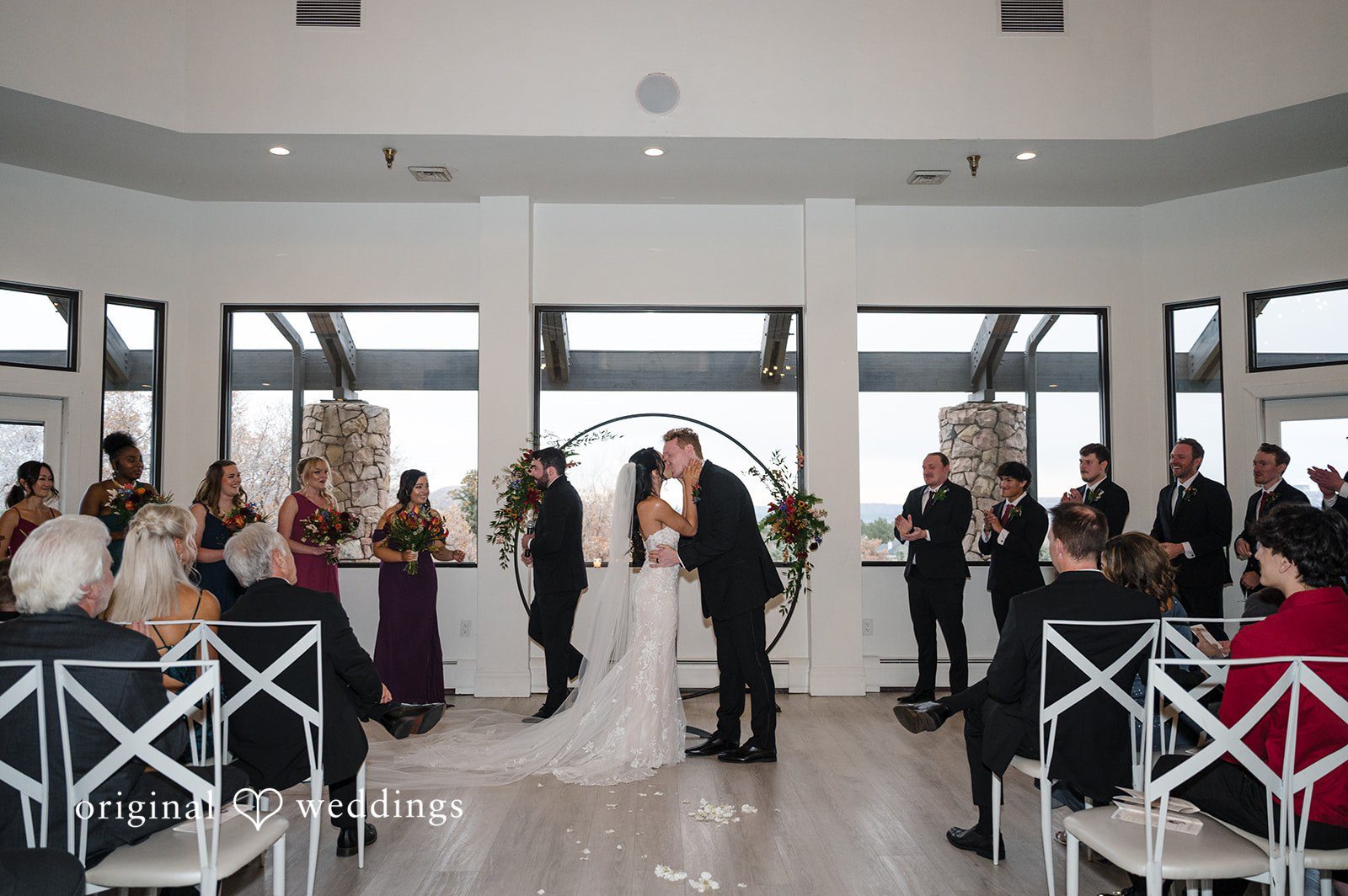 Elegant bride and groom kiss moment at The Oaks