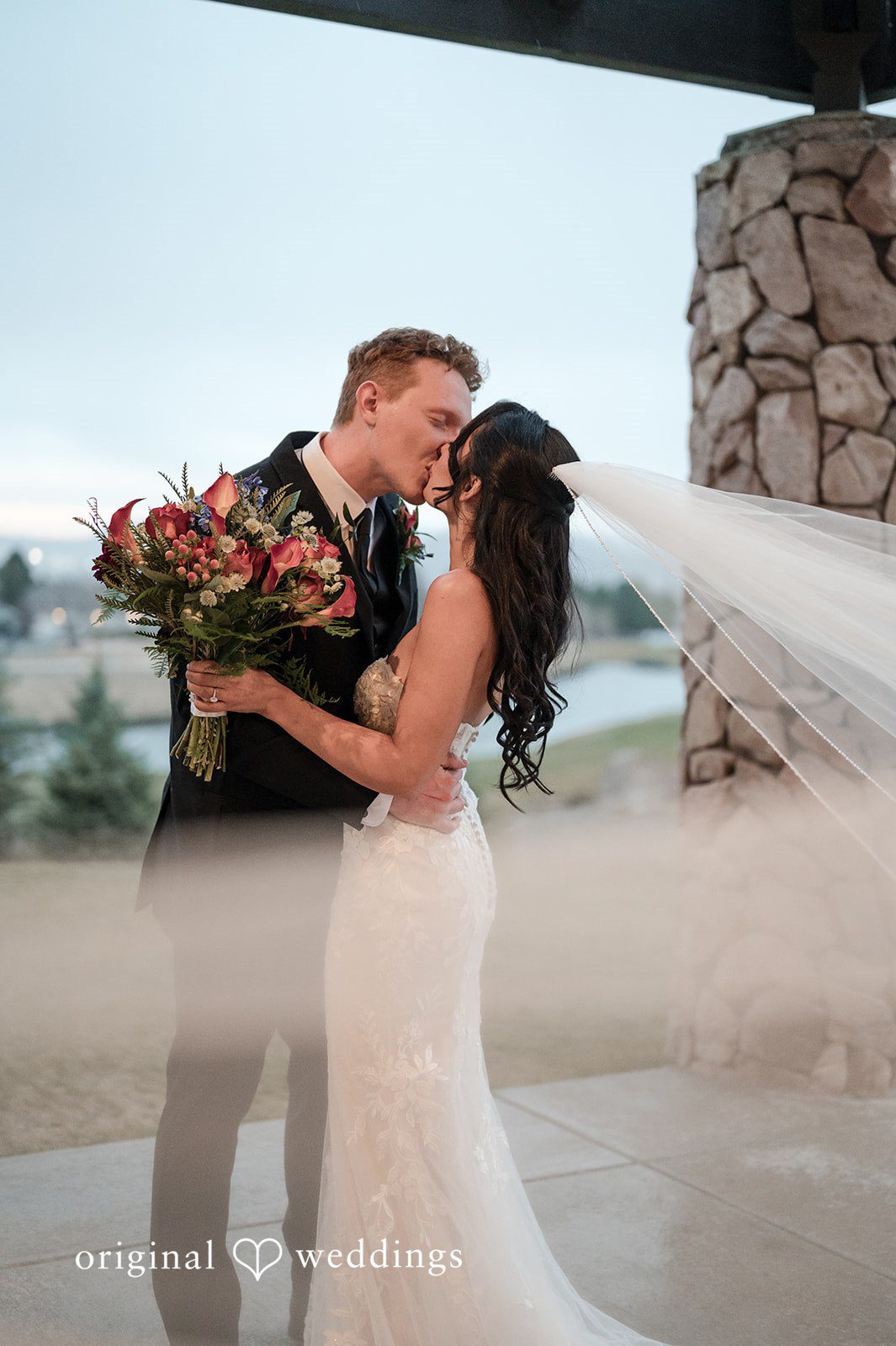 Romantic bride and groom kiss portrait at The Oaks