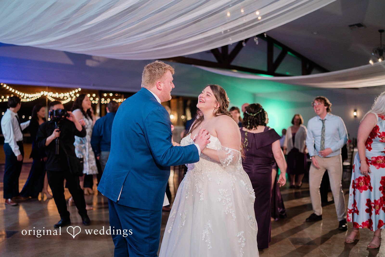 The couple dances happily at their Orchard Event Venue & Retreat wedding reception